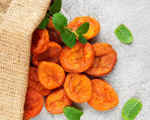Dried apricots on a grey concrete background