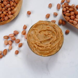 Bowl of peanut butter isolated on white background,