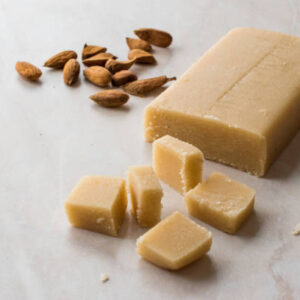 Homemade almond paste whole marzipan on wooden board. organic food.